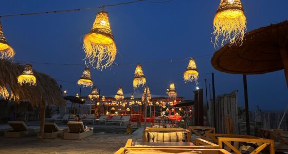 Elegant dinner setup under the stars in Agafay Desert with lanterns and traditional Moroccan decor.