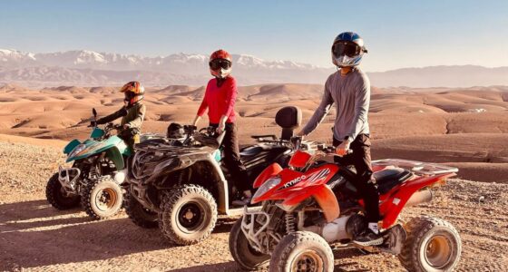 A rider on a quad bike speeding through the golden dunes of the Agafay Desert near Marrakech, with breathtaking rocky landscapes in the background.